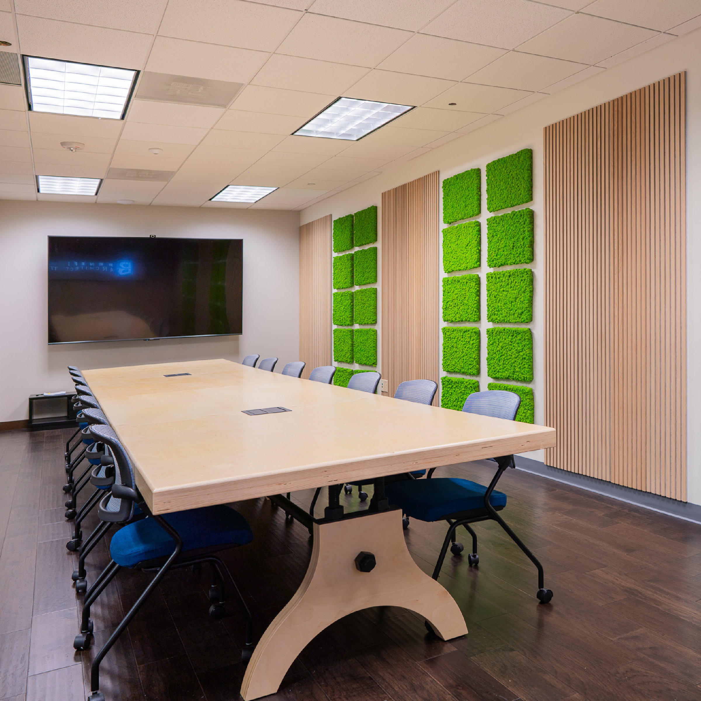 conference room interior design with a custom conference table for benefit architects the interior decor on the walls includes live moss and wood acoustic wall panels