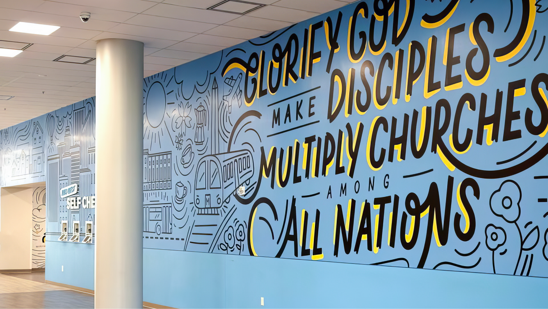 interior wall design at McClean Bible Church located in the kids ministry space wall graphic has different images displayed accompanied by the phrase Glorify God Make Disciples Multiply Churches Among All Nations