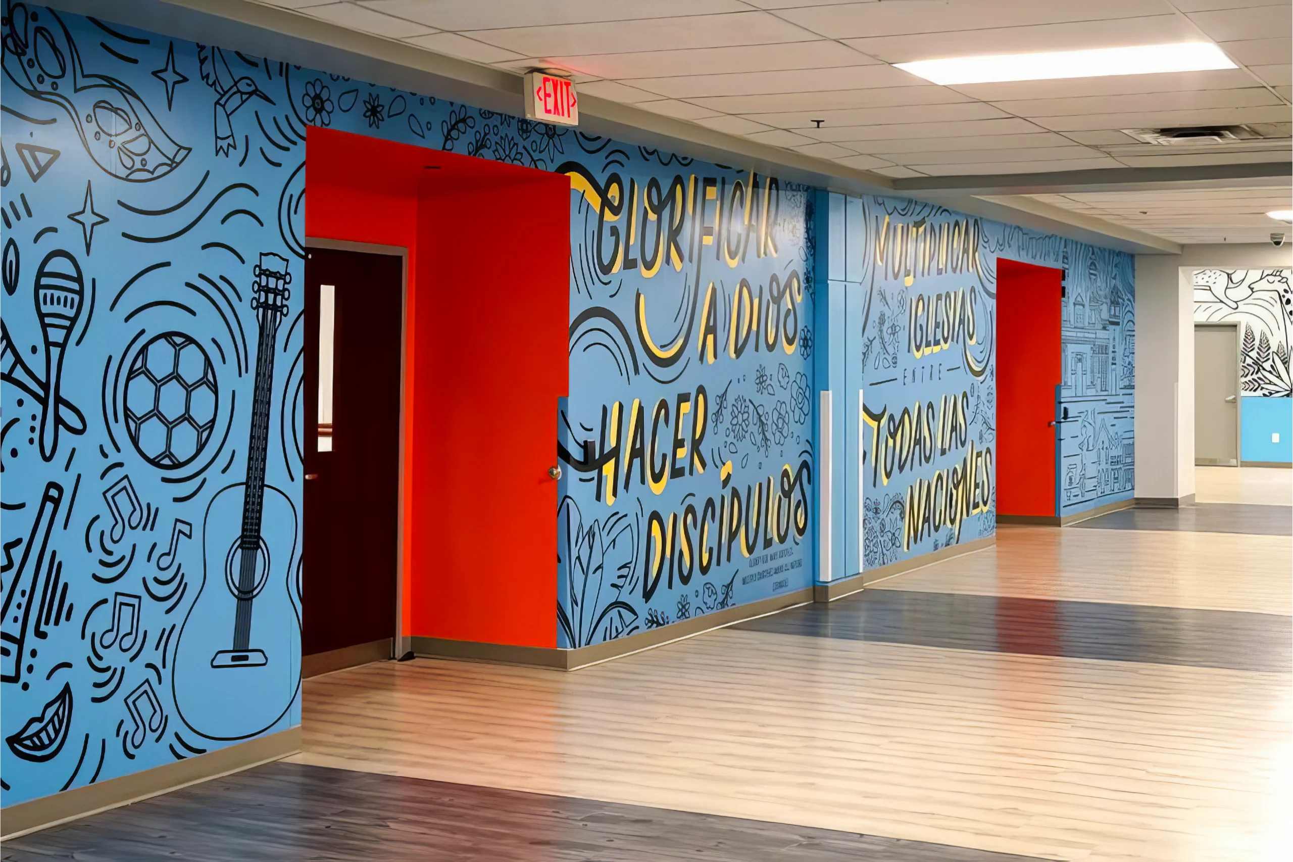 interior wall design at McClean Bible Church located in the kids ministry space wall graphic has different images displayed accompanied by the phrase in Spanish Glorificar a dios hacer discipulos multiplicar iglesias entre todas las naciones