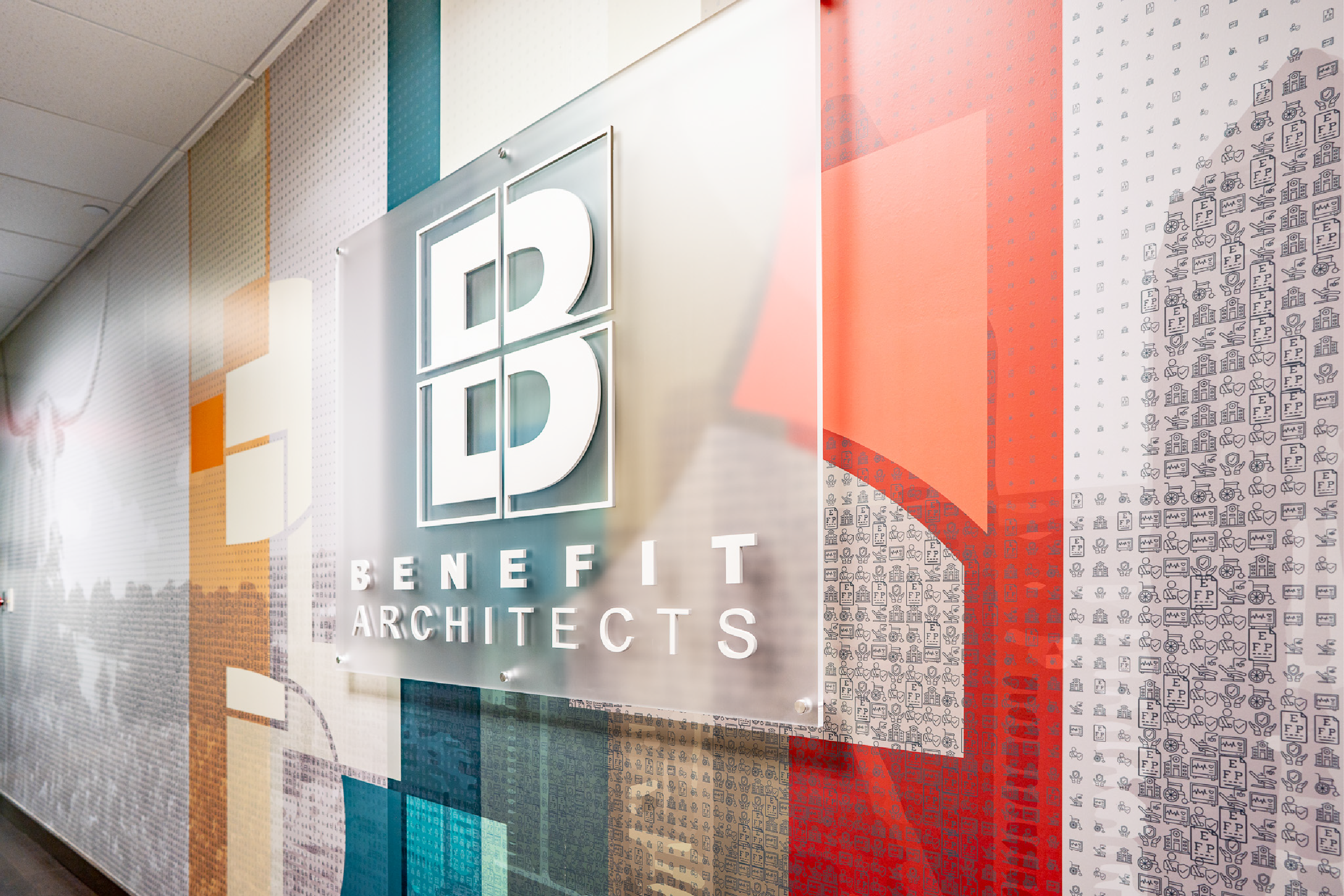 experiential graphic design is located right when you walk into benefit architects with a photomosaic that is paired with interior signage for the company designed by enviropop