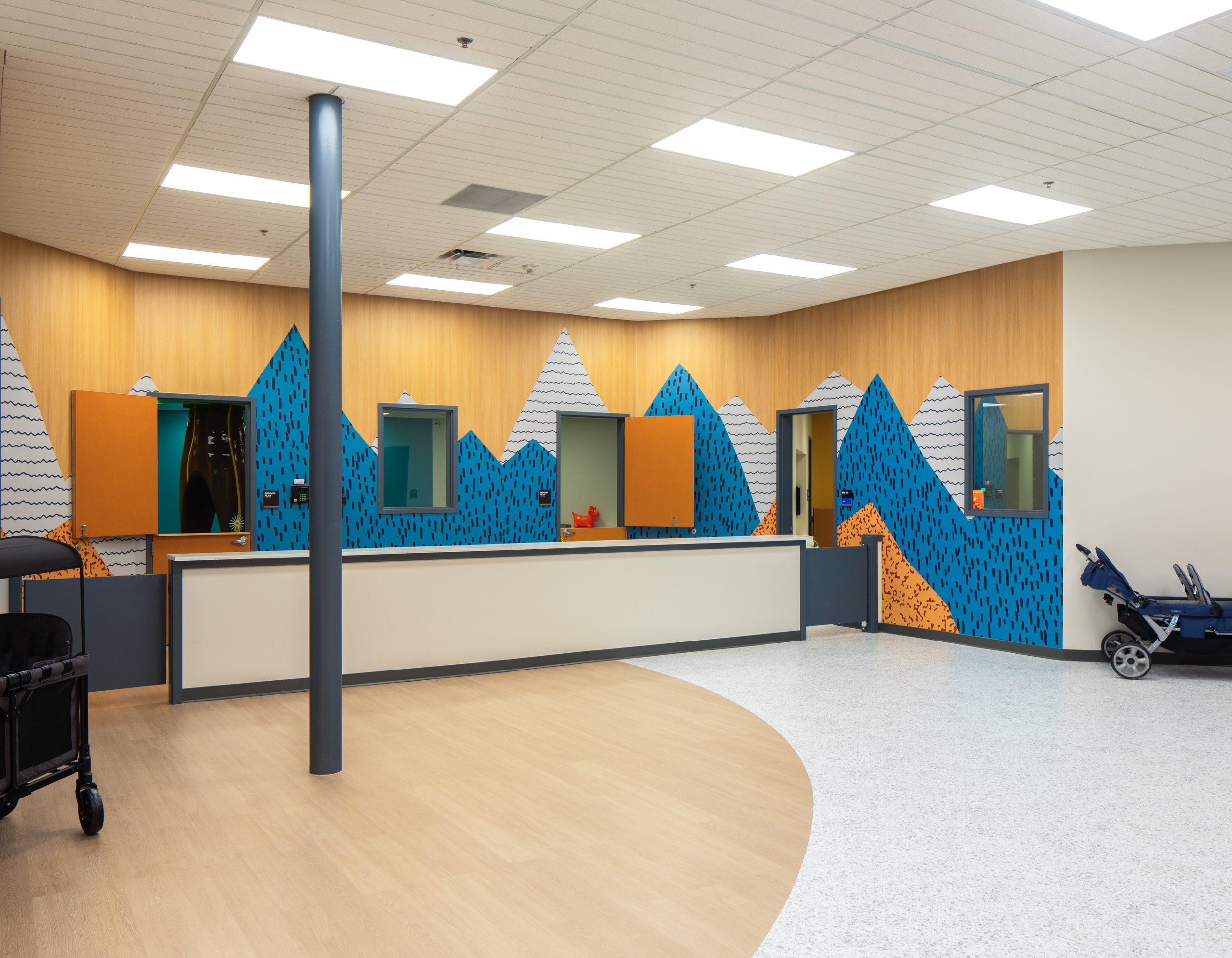Flatirons church nursery check-in desk with branded environment mountain wall graphics and interior signage by Enviropop